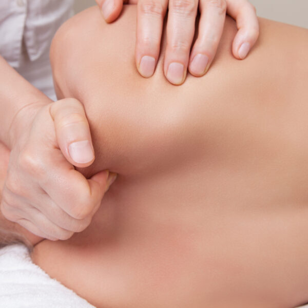 Professional  therapist doing neck and shoulder deep tissue and sport massage